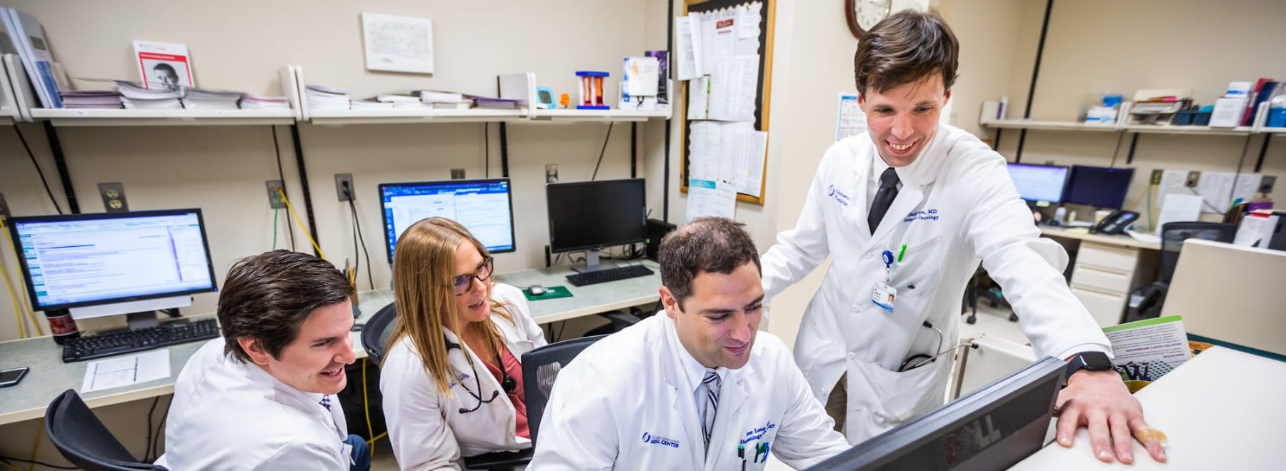 Physicians confer during rounds. Physicians confer during rounds.